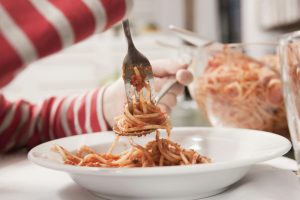 Germany, Cologne, Child eating spaghetti, close-up